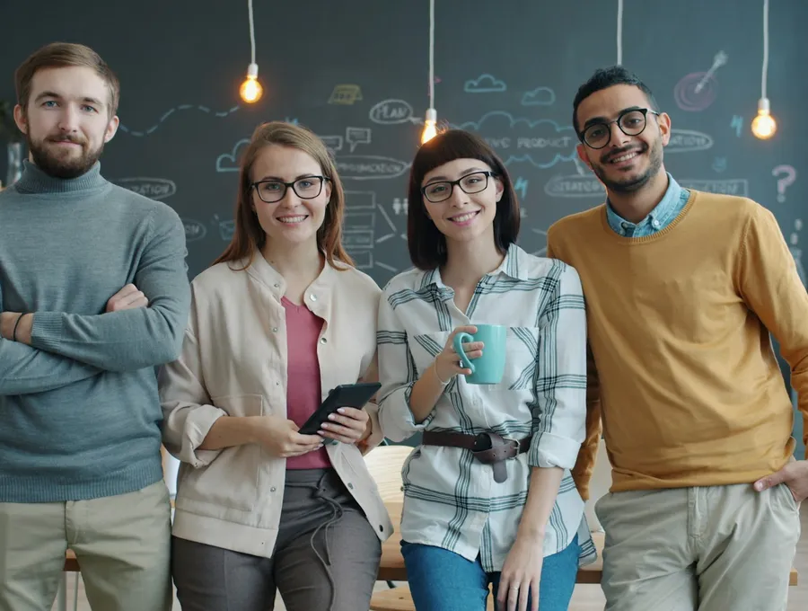 Smiling business team choosing practical website design advice for Bideford businesses - Web Design Bideford | Bloxli Web Design Bideford
